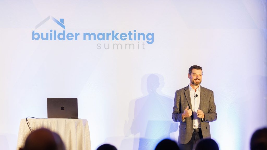 Barrett Davis speaking onstage to guests at the Builder Marketing Summit.