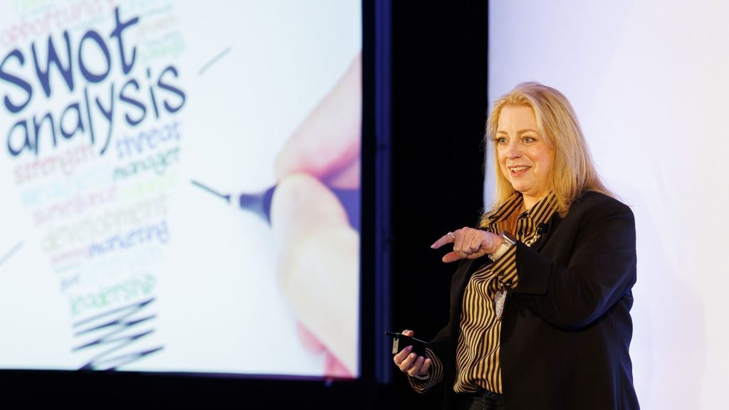 Kimberly Mackey speaking onstage to guests at the Builder Marketing Summit.